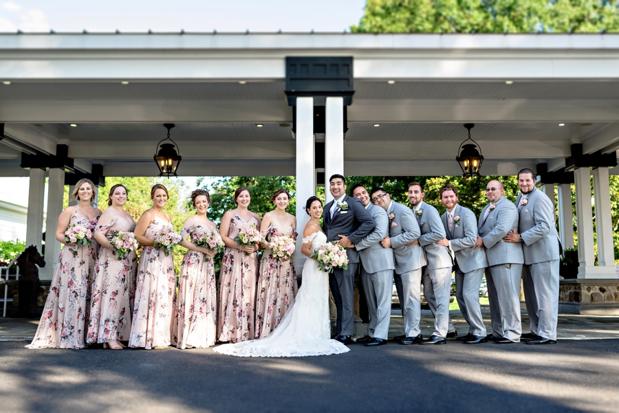 A wedding party at the Ryland Inn pose and act silly.